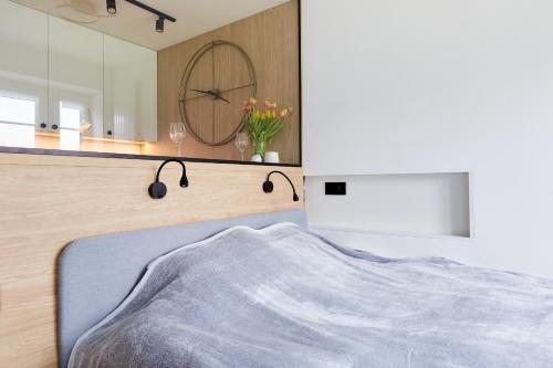 a bedroom with a bed and a mirror at Kamilkowy Apartament in Karpacz