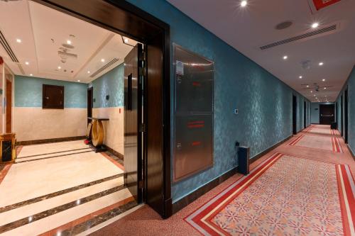 a hallway with a door and stairs in a building at Al Mansour Suites Hotel in Doha