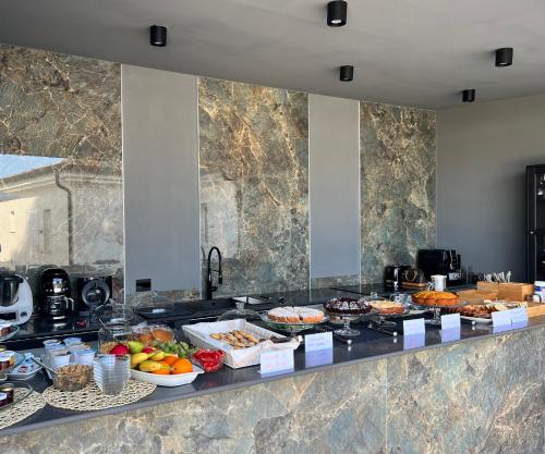 a buffet line with many different types of food at infinity Castellabate b & b di Charme in Santa Maria di Castellabate