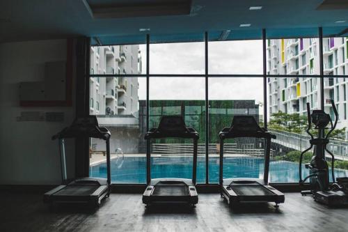 a gym with a swimming pool in a building at Lovely Jazz 1 3bedrooms with 2 Card LV9 in Kuching