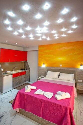 a bedroom with a large bed with two towels on it at RENT HOUSE ANEMOS in Iraklitsa