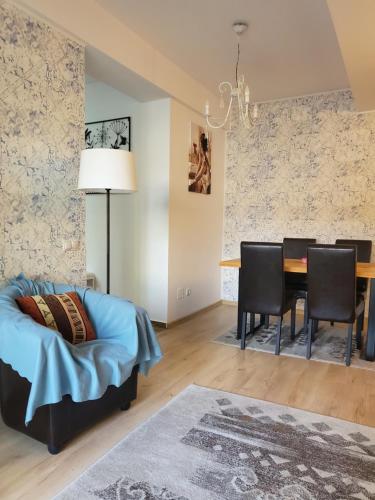 a living room with a couch and a table at Morii Lake Apartment in Bucharest
