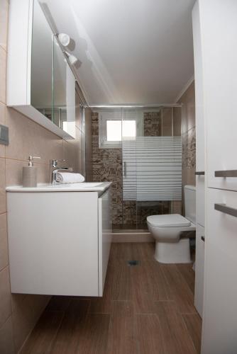 a bathroom with a white sink and a toilet at ENIO AXD guest house with private parking in Alexandroupoli