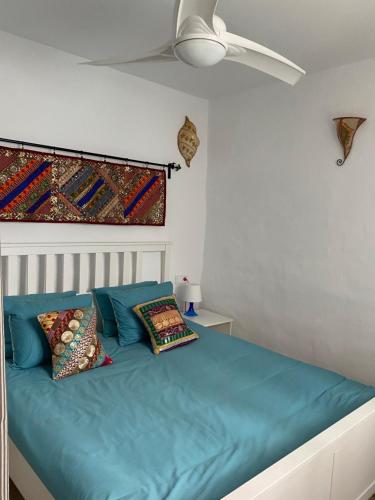 a bedroom with a blue bed with a ceiling at Cheerful one bedroom townhouse with patio Archez in Árchez