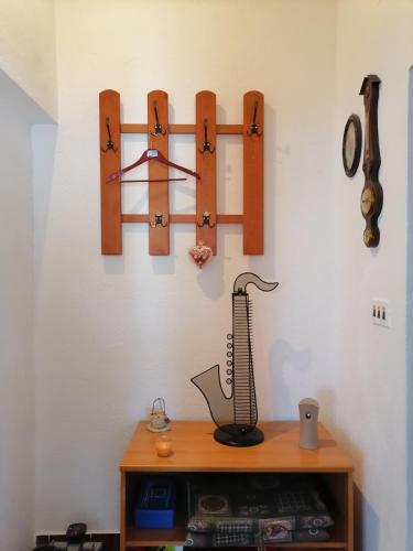 a shelf with a scale and clocks on a wall at Apartments Vedrana in Ražanj