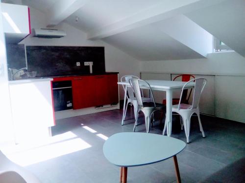 a kitchen with a table and chairs in a room at 3P Masséna Old Nice last stage in Nice