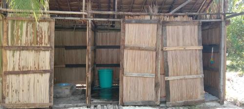 a building with wooden doors and a bucket at Raja Ampat Jousuba Homestay in Minyaifuin
