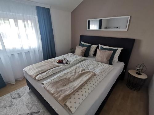 a bedroom with a large bed with a blanket on it at King's Cave deluxe in Jajce