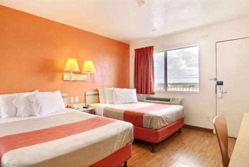 a hotel room with two beds and a window at Motel 6-Fort Stockton, TX in Fort Stockton