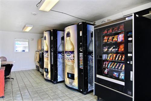 a row of refrigerators in a room with drinks at Motel 6-Fort Stockton, TX in Fort Stockton