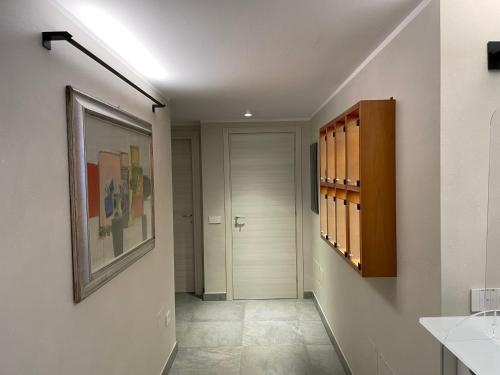 a bathroom with a hallway with a walk in closet at Le Petit Du Lac in Sirmione
