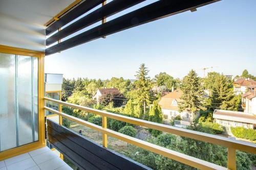 a balcony with a view of trees and buildings at ApartManó in Balatonfüred