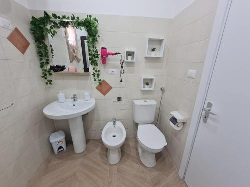 a white bathroom with a sink and a toilet at Sweet Home Airport in Catania