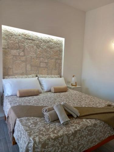 a bedroom with a bed with two towels on it at Donsanto Casa Vacanze in Taormina