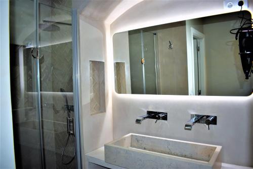 a bathroom with a sink and a mirror at Apartamentos Colmeia in Lisbon