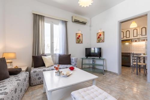 a living room with a couch and a table at Marialena Rooms in Skopelos Town