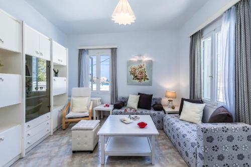 a living room with a couch and a table at Marialena Rooms in Skopelos Town