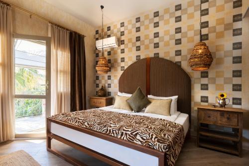 a bedroom with a large bed and a window at La Capria Suite Hotel Alacati in Alacati