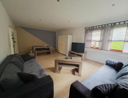 a living room with a couch and a table at Ferienwohnung Struppi Sächsische Schweiz in Struppen