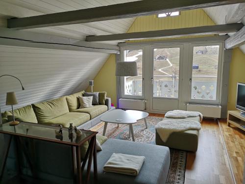 a living room with a couch and a table at Gasthaus Friedegg in Wildhaus