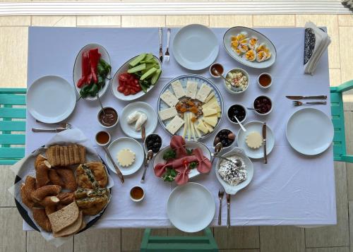 a table with plates and bowls of food on it at The Aegean Gate Hotel in Bodrum City