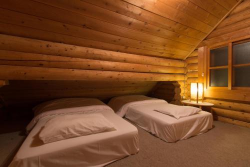Postel nebo postele na pokoji v ubytování Moiwa Lodge