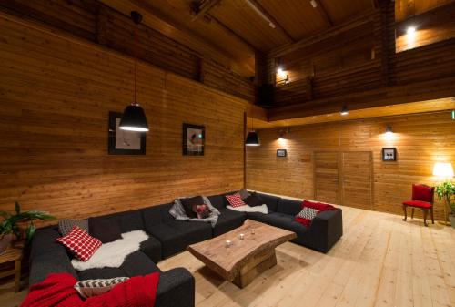 a living room with a couch and a coffee table at Moiwa Lodge in Niseko