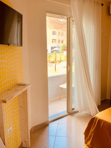 a bedroom with a sliding glass door to a balcony at Family Tree - WATER Available - SELF check in in Golem