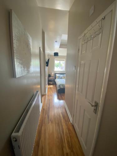 a hallway with a white door and a bedroom at Private room and bathroom with private entrance near Warwick town centre in Warwick