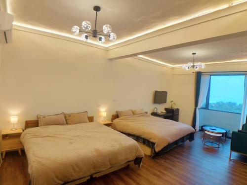 En eller flere senge i et værelse på 海灣旅宿