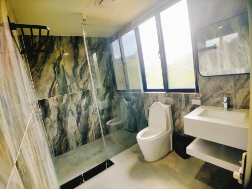 a bathroom with a toilet and a sink at 海灣旅宿 in Sanzhi