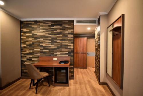a dining room with a table and a brick wall at King Solomon Batumi Hotel in Batumi
