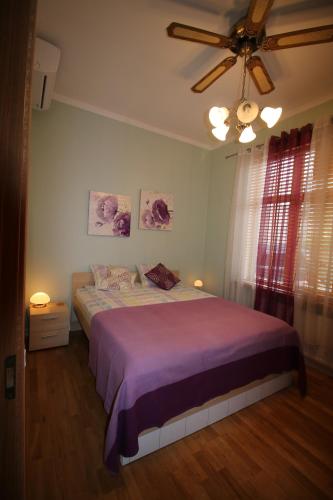 a bedroom with a bed and a ceiling fan at Sääse Apartments in Pärnu