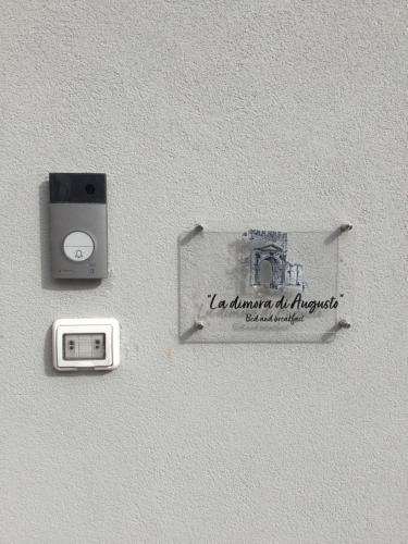 a sign on a wall with a socket and aswitch at La dimora di Augusto in Rimini
