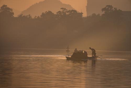 a group of people on a boat in the water at Carambola Bungalow in Phong Nha