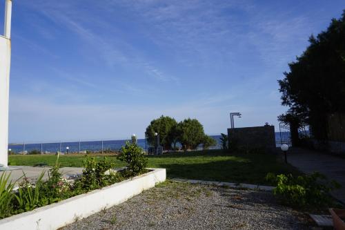a view of a park with the ocean in the background at Nicholas Waves Beach Studios in Lardos
