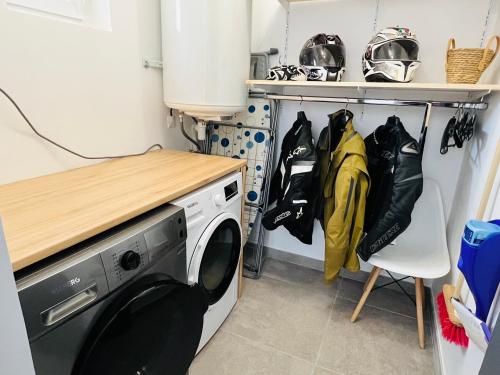 a laundry room with a washing machine and a table at Sleep & Road in Couteuges