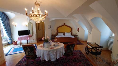 a bedroom with a bed and a table in a room at Hotel zum Riesen in Miltenberg