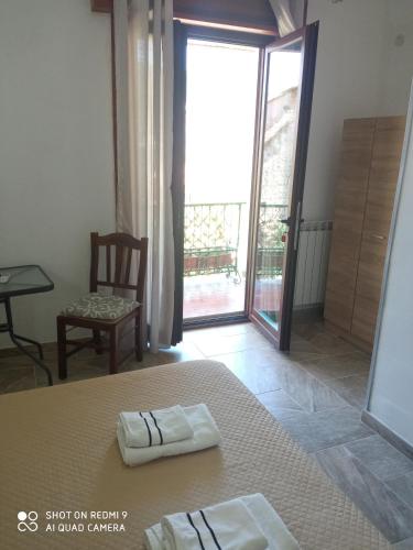 a bedroom with a bed and a door to a balcony at Bed & Breakfast Il Sentiero in Agerola