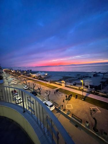 a view of a city at sunset with cars parked at La Baia Di Ulisse in Venetico
