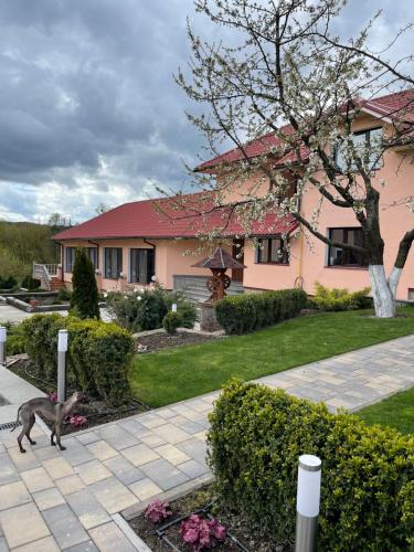 a monkey walking in front of a house at Приватний будинок для сімейного відпочинку з басейном і сауною in Hryhorivka
