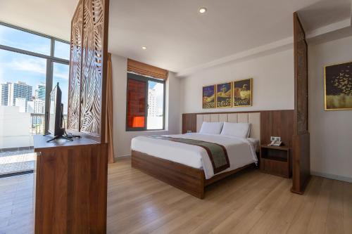 a bedroom with a bed and a large window at Simon Hotel in Nha Trang