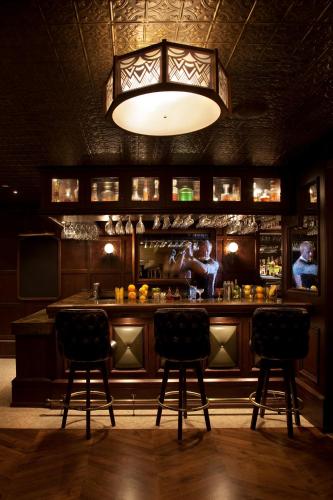 a bar with two chairs in front of it at The Hollywood Roosevelt in Los Angeles