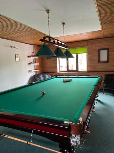 a billiard room with a pool table in it at Приватний будинок для сімейного відпочинку з басейном і сауною in Hryhorivka