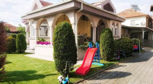 a house with a slide in the front yard at Mile in Prilep