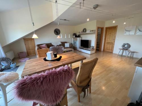 a living room with a wooden table and chairs at Schmidt's Plaats in Norden