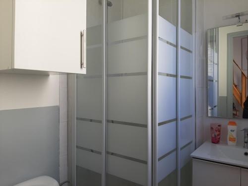 a bathroom with a glass cabinet and a sink at Le Fontana in Nice