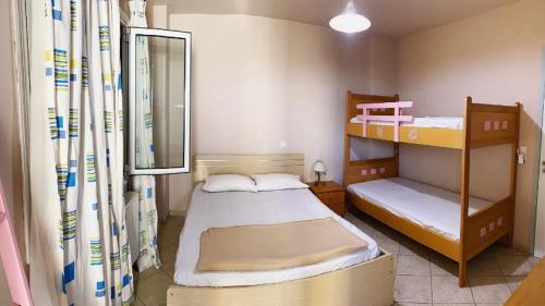 a bedroom with two bunk beds and a mirror at SAINT GEORGE in Karteros