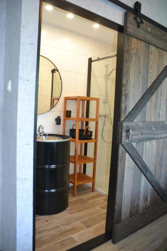 a bathroom with a shower and a sink and a door at Nikolaierhaus in Feldkirchen in Kärnten