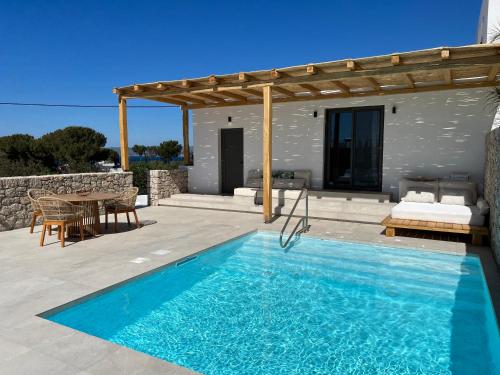 a villa with a swimming pool and a house at Milos Villas Complex in Pefki Rhodes